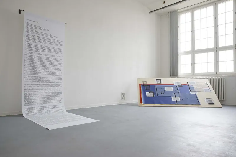Detail of a blue board with photographs of a beach and short texts